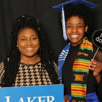 two students holding props for a picture
